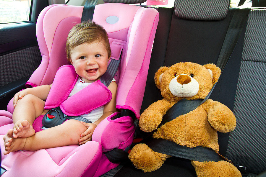 bigstock-Baby-Girl-Smile-In-Car-38034541-1.jpg