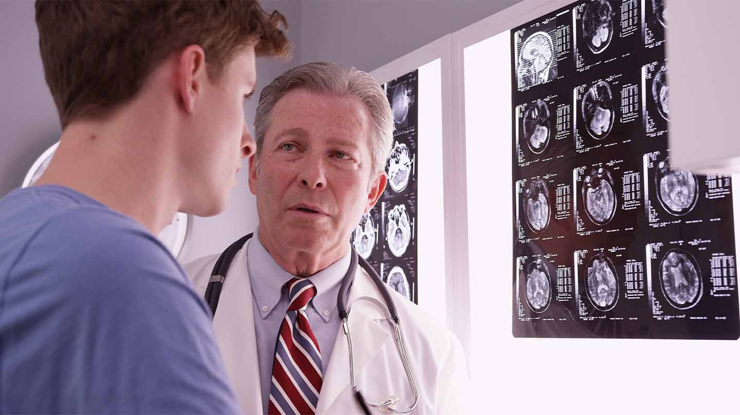 Doctor talks to a patient about his brain injury